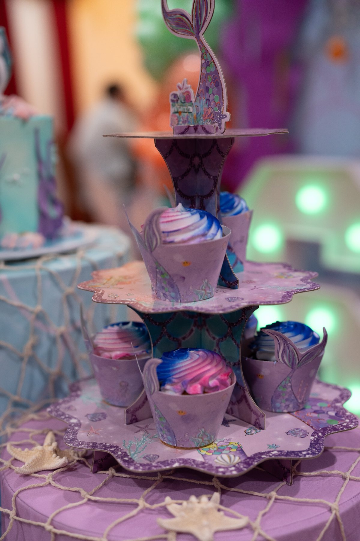 Mermaid-themed cupcake tower at a birthday party