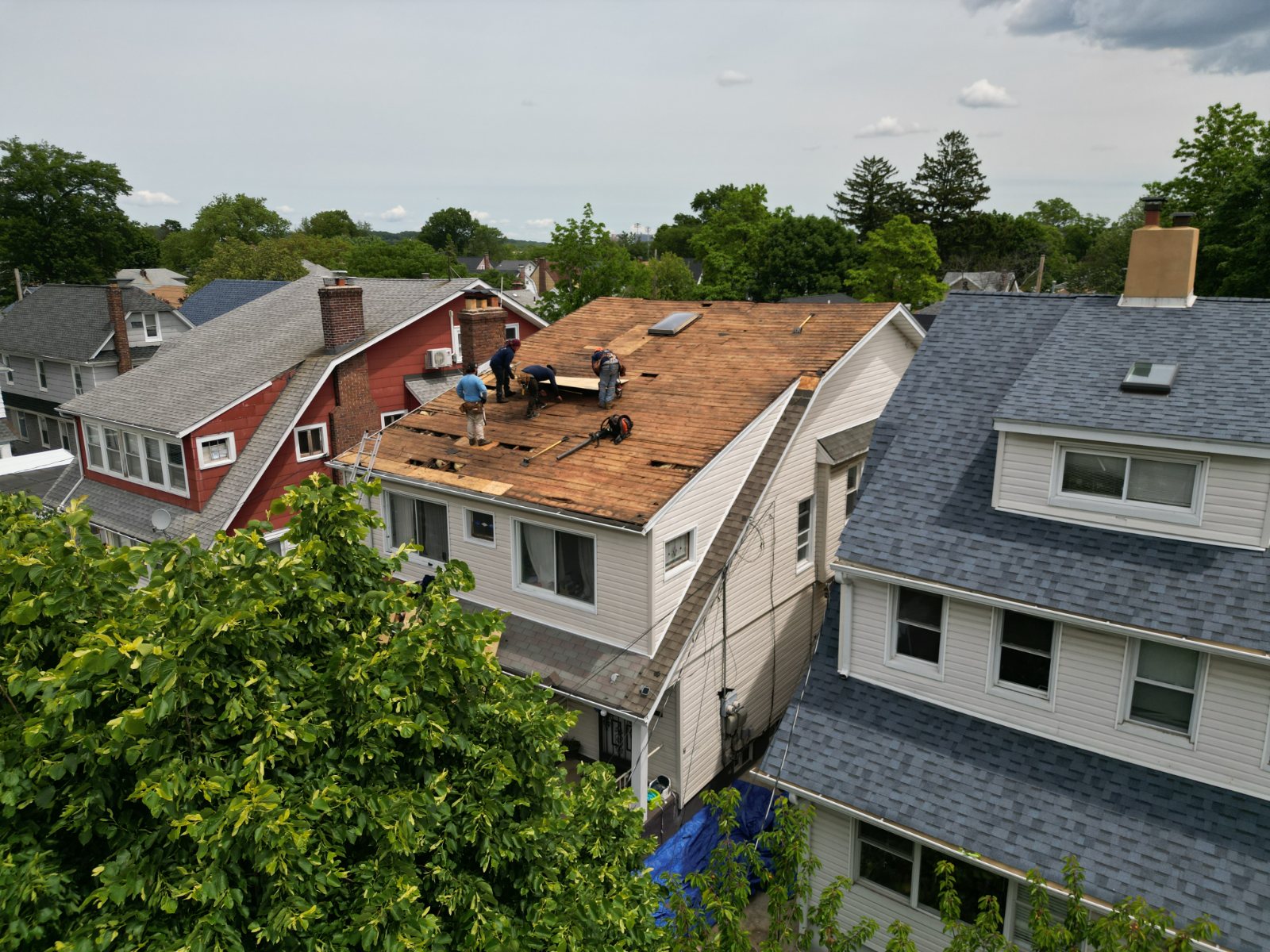 Aerial drone view of a roofing crew at work