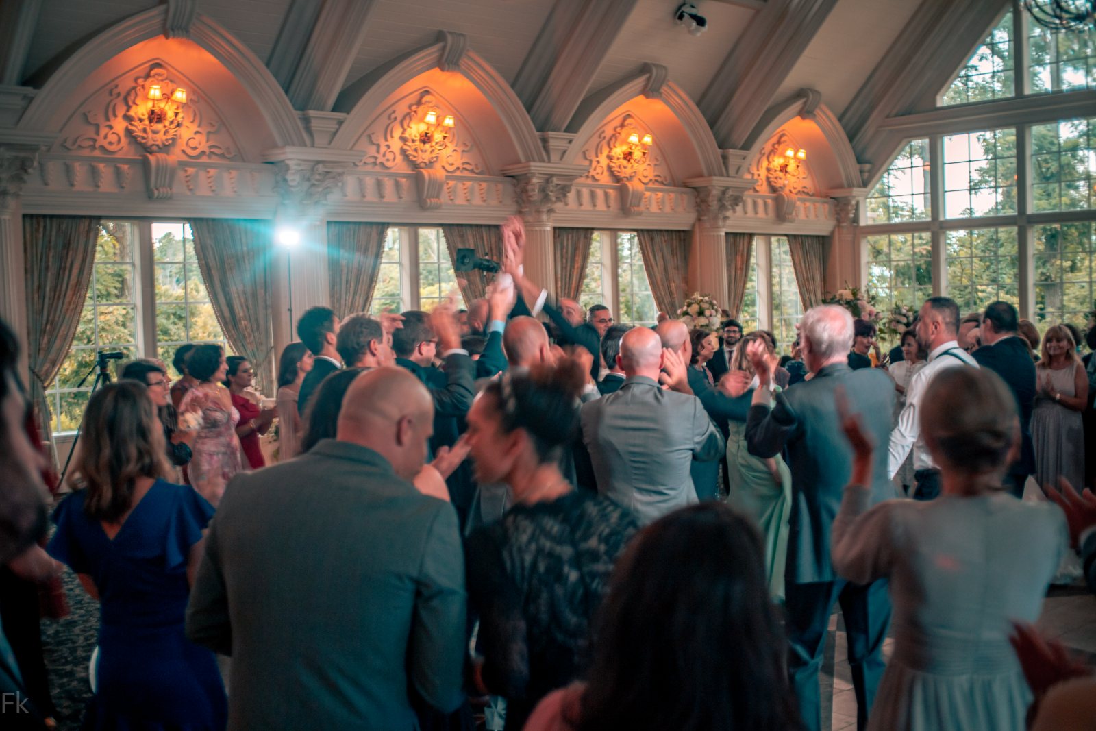Drummer leading a wedding entrance as guests clap